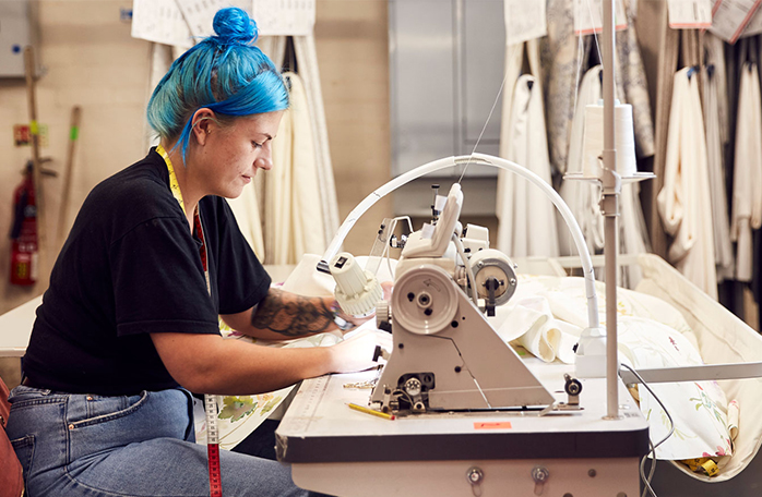 Woman working on sewing machine