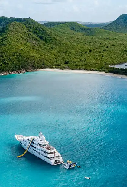 A luxury yacht moored in an azure sea